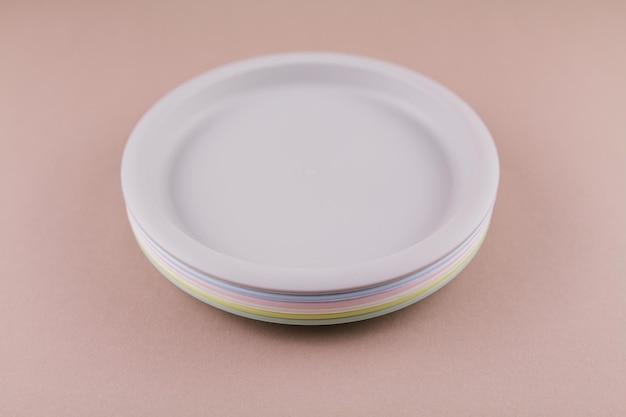 A set of plastic reusable colorful plates on the kitchen table