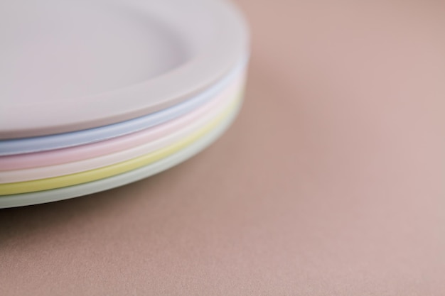 A set of plastic reusable colorful plates on the kitchen table