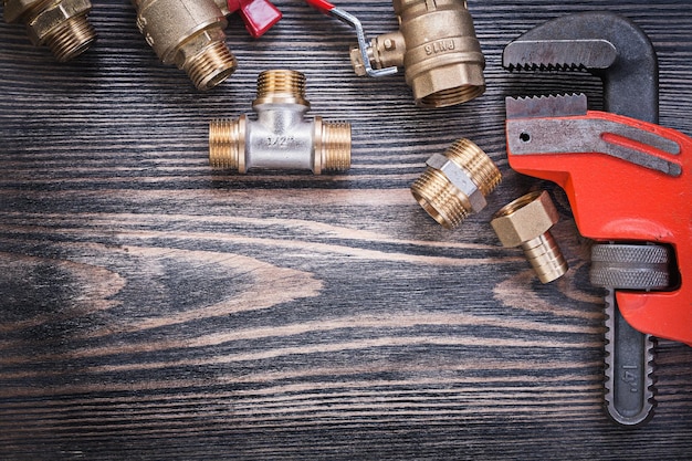 Photo set of plumbers tools on wooden board plumbing concept.