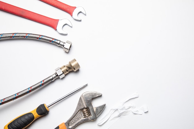 Set of plumbing and tools on the white