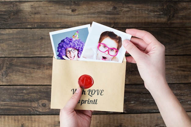 a set of polaroid photos in hands