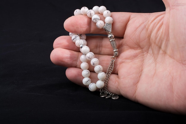 Set of praying beads of various color in hand