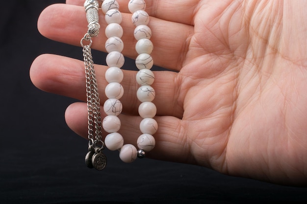 Set of praying beads of various color in hand