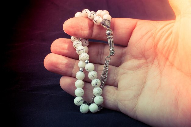 Set of praying beads of various color in hand