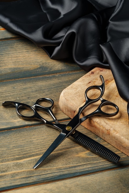 Set of professional barber tools on wooden table