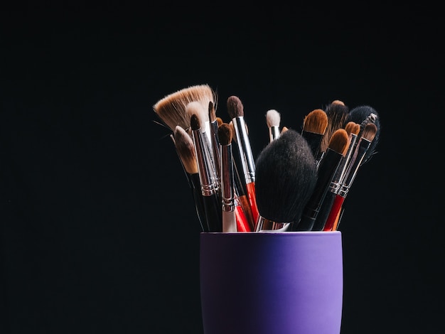 Set of professional makeup brushes close up with copy space