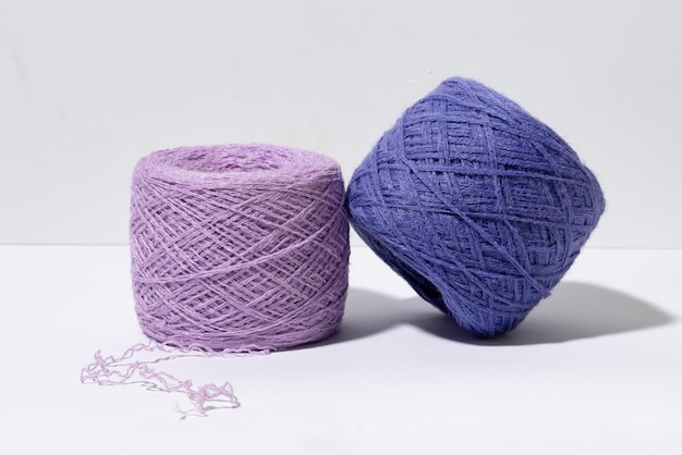 A set of purple skeins of knitting thread with a shade from hard light Craft and hobby materials concept