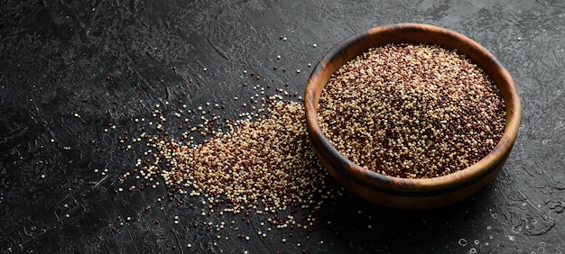 Set of quinoa Red white and brown quinoa On a black background Top view Free copy space