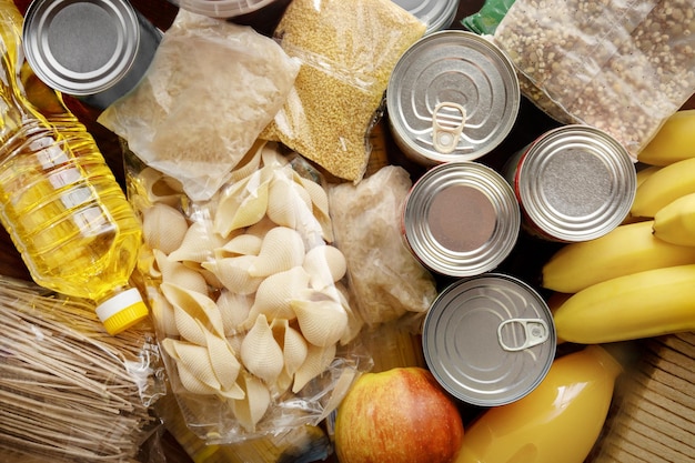 Set of raw cereals grains pasta canned food and oil on the table