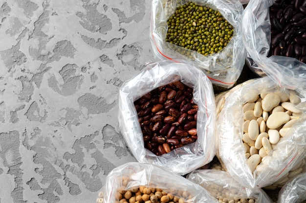 Set of raw cereals, grains, pasta and canned food on the table.