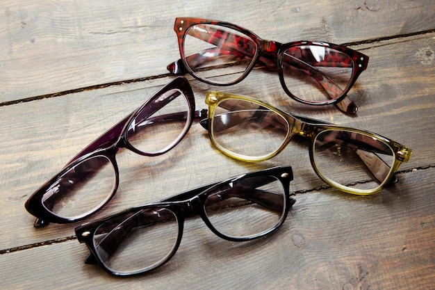 Set of reading glasses on wooden background