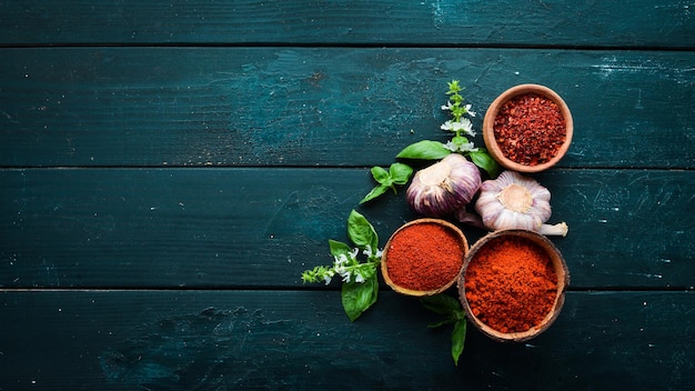 A set of red spices on a black background Paprika chili pepper Top view