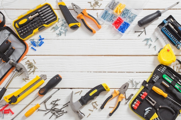 Set of repair tools on white  wooden surface