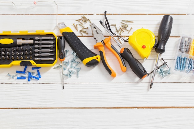 Set of repair tools on white  wooden table