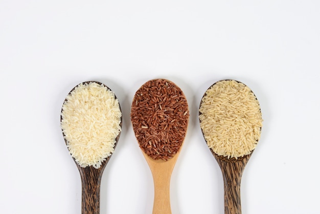 Set of rice collection on ladle on wood texture