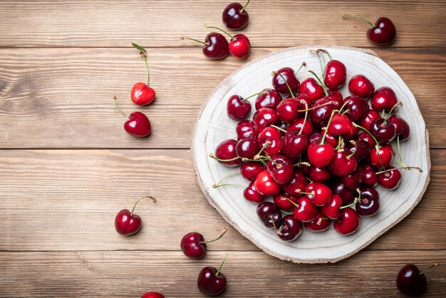 Set of rich and healthy red cherries on a wooden base Fruits rich in vitamins for a healthy diet