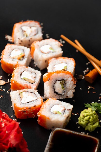 Set of rolls on a dark background with Chinese chopsticks