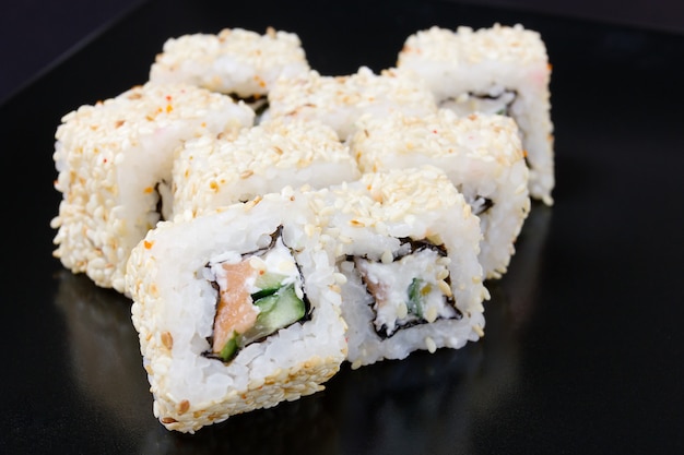 Set of rolls with salmon, cheese, sesame