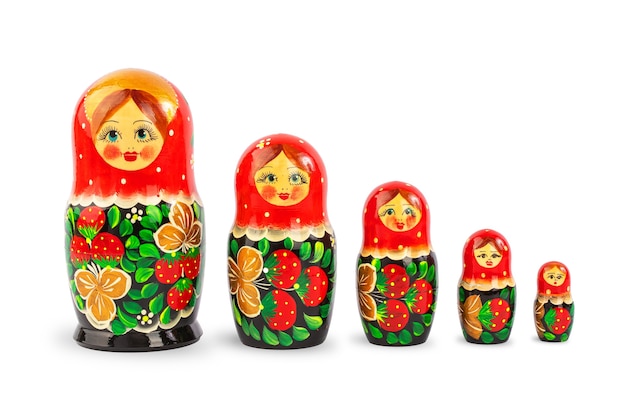 Photo a set of russian folk wooden dolls covered with patterns isolate on a white background