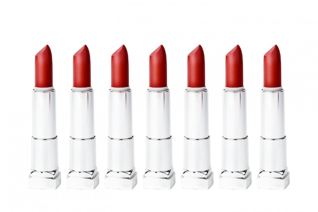 Set of same red lipstick tubes isolated on white 