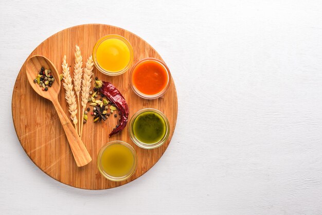 A set of sauces and spices. On a wooden background. Top view. Free space for text.