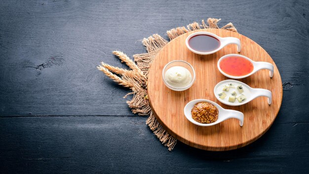 A set of sauces and spices On a wooden background Top view Free space for text