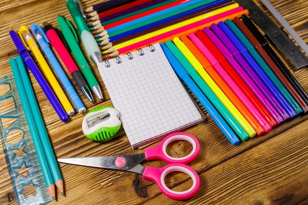 Photo set of school stationery supplies on a wooden desk back to school concept