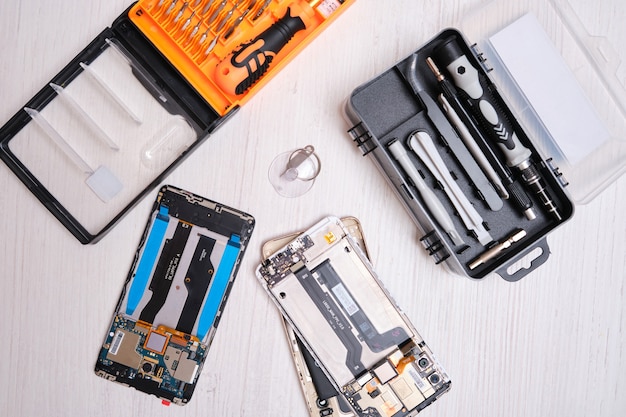 set of screwdriver bits in a black box, gloves, tools for replacing the glass of the phone and tablet