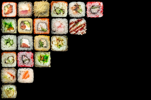 Set of seafood - isolated rolls on black background.