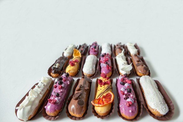 Set of several eclairs with various fillings and designs, the concept of French cuisine