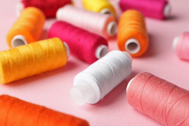 Set of sewing threads on color background