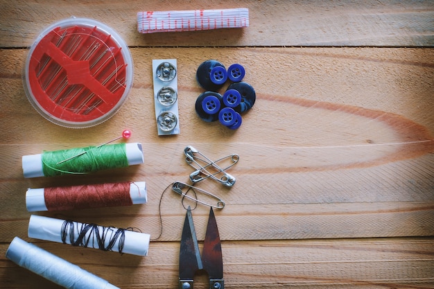 Set of sewing tools on wooden table