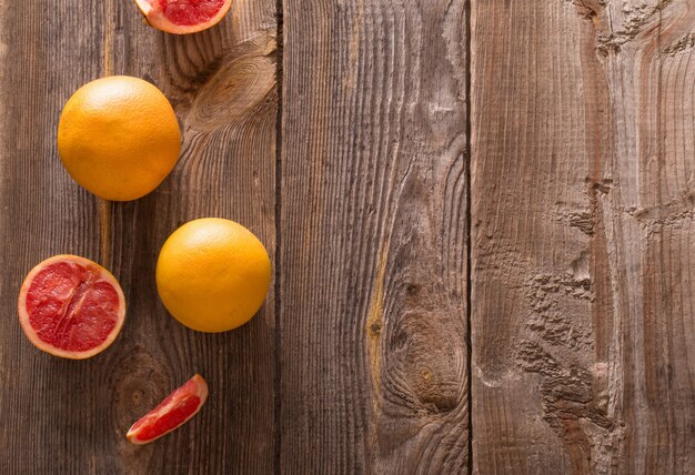 Set of sliced citrus fruits over wooden table