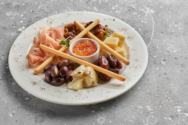 Set of snacks for wine. Prosciutto, parmesan, gorgonzola, almonds, olives, bread chips