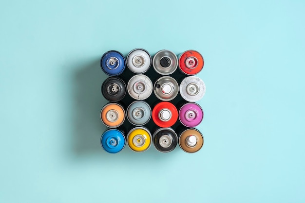 A set of some spray paint cans of different colors flat lay