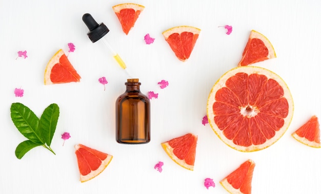 Photo set of spa mineral salt grapefruits bottle of grapefruit liquid product colourful decorate with mint leaves