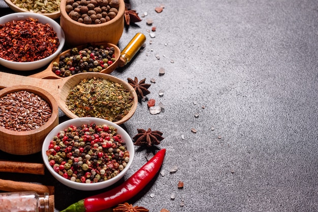 A set of spices and herbs. Indian cuisine. Pepper, salt, paprika, basil and other. Top view.