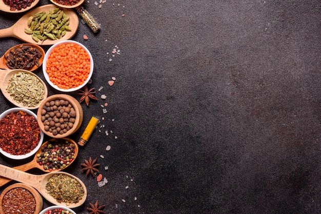 A set of spices and herbs. Indian cuisine. Pepper, salt, paprika, basil and other. Top view.