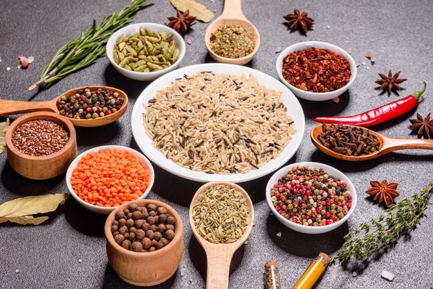 A set of spices and herbs. Indian cuisine. Pepper, salt, paprika, basil and other. Top view.