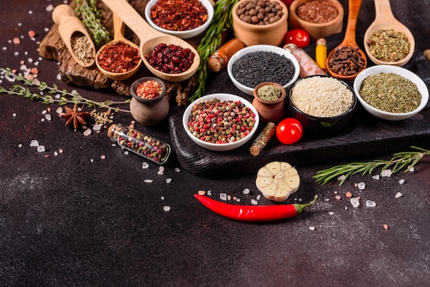 A set of spices and herbs. Indian cuisine. Pepper, salt, paprika, basil. Top view.