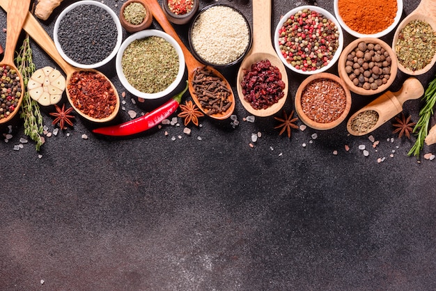 A set of spices and herbs. Indian cuisine. Pepper, salt, paprika, basil. Top view.