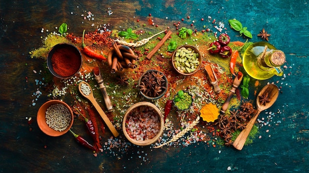 Photo set of spices and seasonings on a black stone background top view