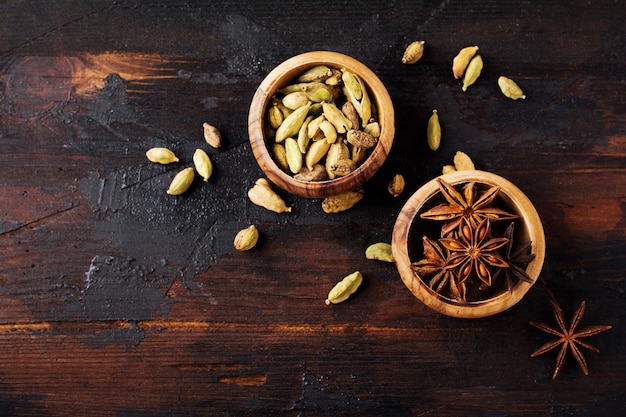 Set of spices of star anise, cardamom, cinnamon and brown sugar on old wooden background. Flat lay.