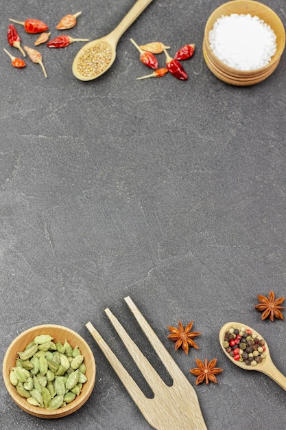 Set of spices and wooden spoons and fork