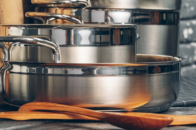 Set of stainless steel saucepans in a kitchen