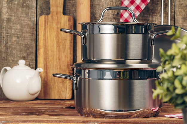 Set of stainless steel saucepans in a kitchen