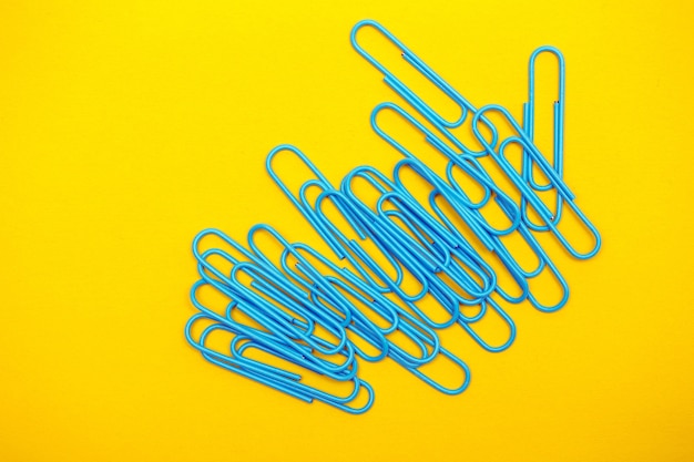 Photo set of stationery - blue clips on a yellow background