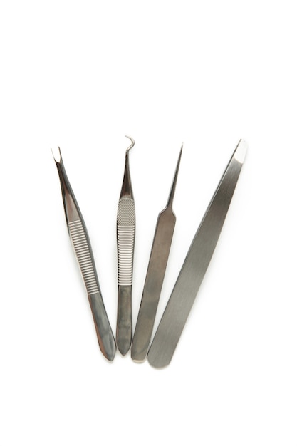 Set of steel tweezers isolated on the white surface