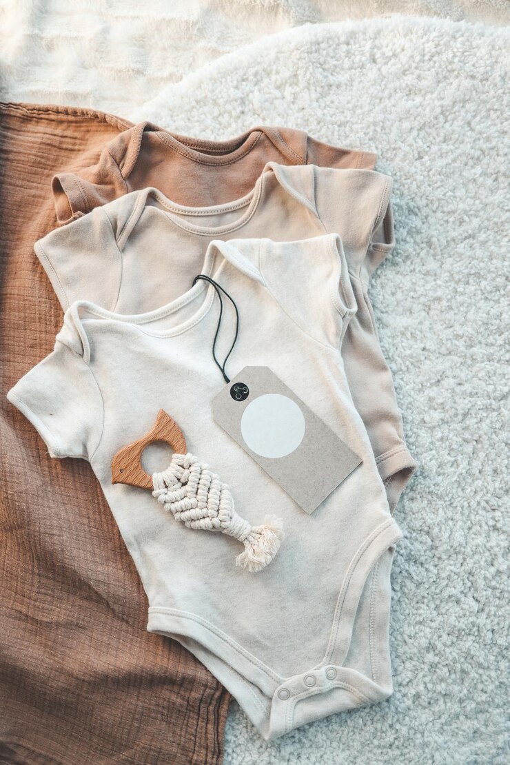 Photo set of stylish cute baby bodysuits and an empty tag for your logo