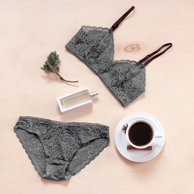 Set of stylish sexy lace lingerie with coffee cup